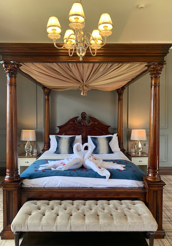 Four poster bed with swan towels